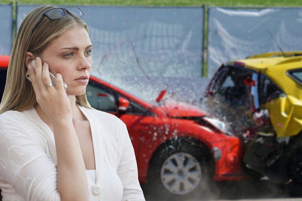 Woman calling her insurance company after an accident, her car is totalled